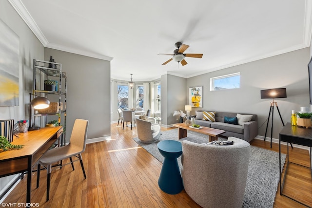 living room featuring light hardwood / wood-style floors, plenty of natural light, and crown molding