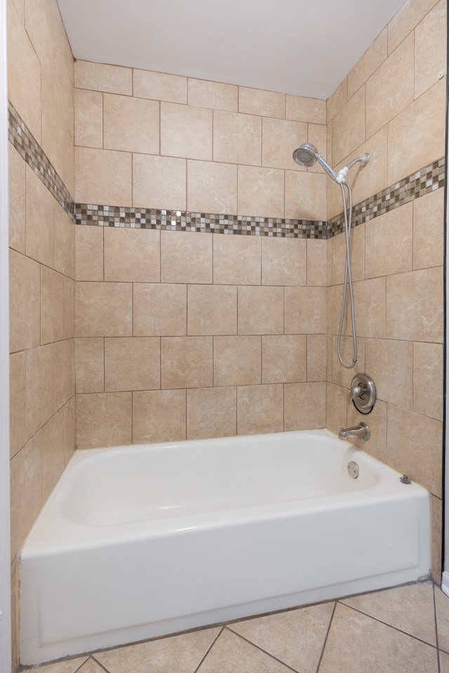 bathroom with tile patterned flooring and tiled shower / bath