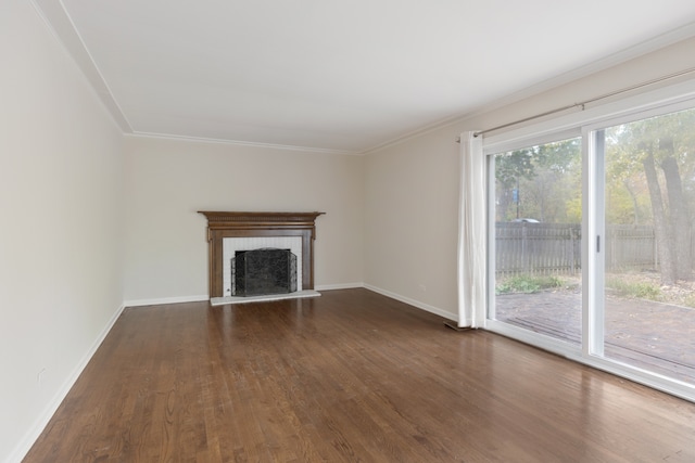 unfurnished living room featuring ornamental molding, dark wood-type flooring, and a brick fireplace