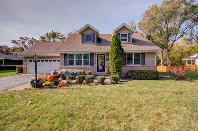 new england style home with a garage and a front lawn