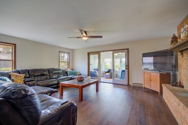 living room with ceiling fan, a fireplace, baseboard heating, and dark hardwood / wood-style floors