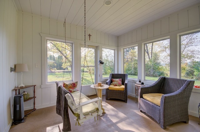 sunroom featuring lofted ceiling and wood ceiling