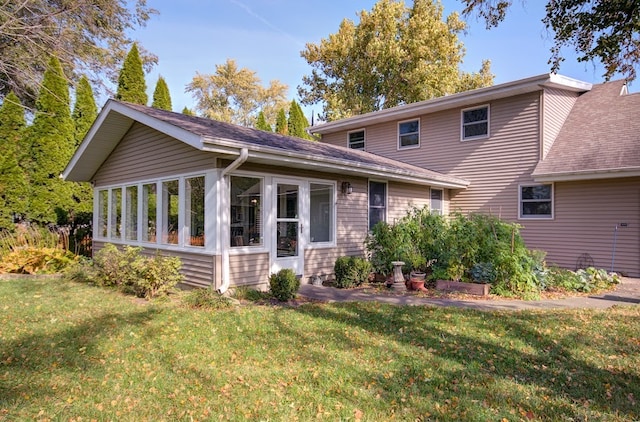 view of front of home featuring a front lawn and a sunroom