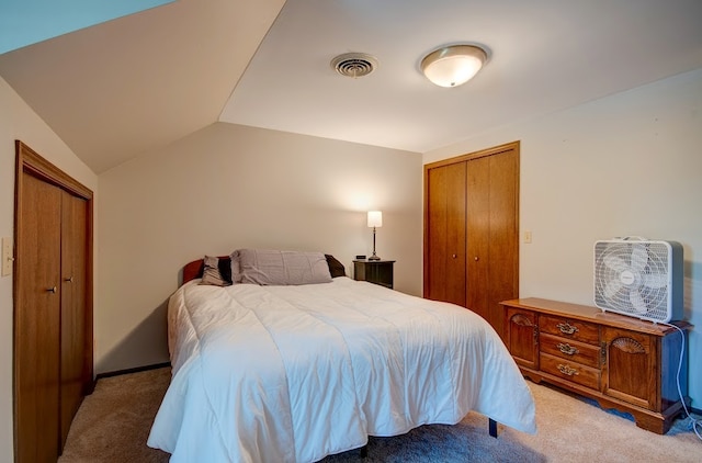 carpeted bedroom with lofted ceiling