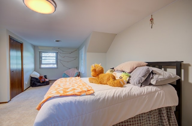 carpeted bedroom featuring vaulted ceiling