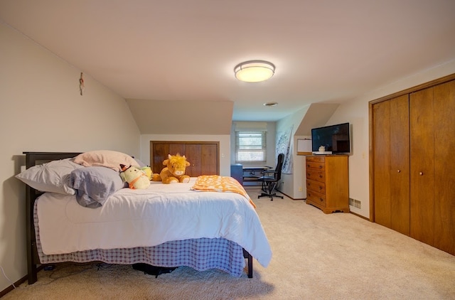 bedroom featuring carpet and vaulted ceiling