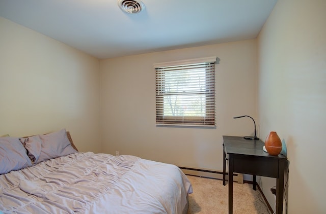 carpeted bedroom with a baseboard heating unit