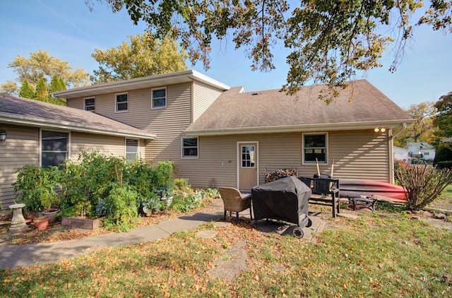 rear view of house with a yard