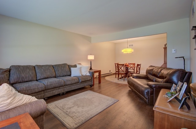 living room featuring hardwood / wood-style floors and a baseboard heating unit