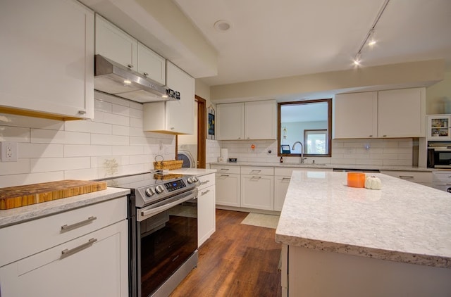 kitchen featuring tasteful backsplash, sink, stainless steel range with electric cooktop, white cabinetry, and dark hardwood / wood-style floors