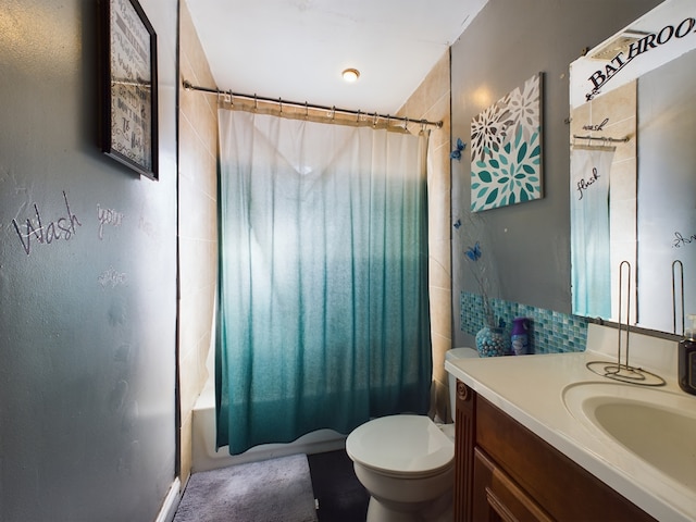 full bathroom featuring vanity, shower / bath combo with shower curtain, and toilet