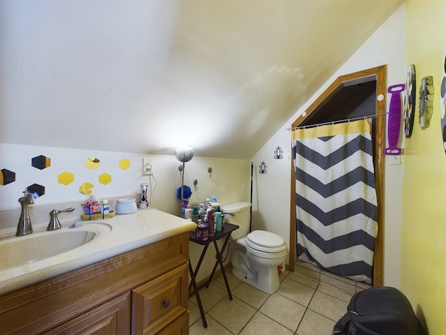 bathroom featuring vanity, lofted ceiling, toilet, and tile patterned flooring