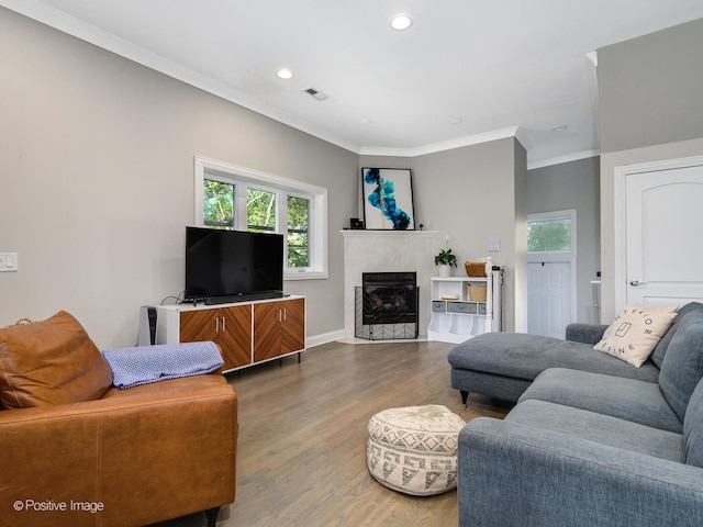 living room with hardwood / wood-style flooring and ornamental molding