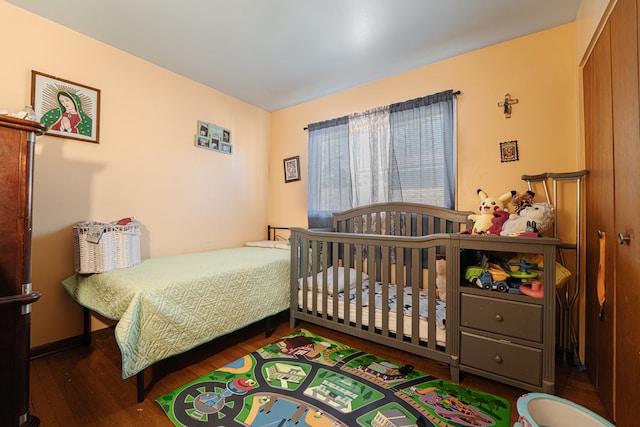 bedroom with dark hardwood / wood-style flooring