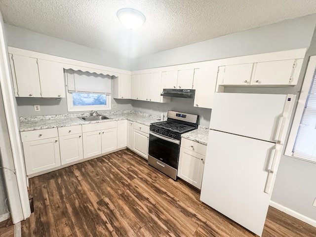 kitchen with sink, stainless steel range with gas stovetop, white cabinets, and white fridge