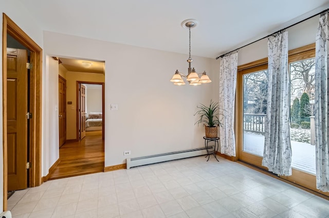 unfurnished room featuring baseboard heating and an inviting chandelier