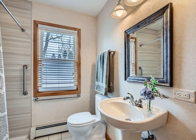 bathroom with a baseboard heating unit, tile patterned floors, sink, and toilet