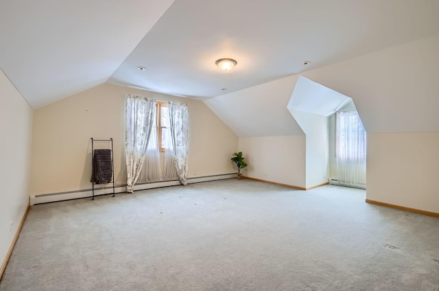 bonus room featuring vaulted ceiling, light carpet, and a baseboard heating unit