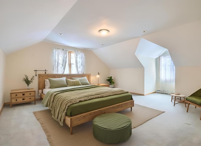 bedroom featuring multiple windows, vaulted ceiling, and light colored carpet