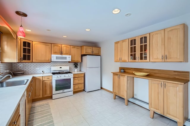 kitchen with pendant lighting, sink, white appliances, light brown cabinetry, and decorative backsplash