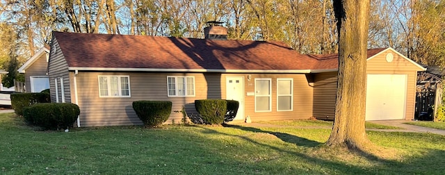 view of front of home featuring a garage and a front lawn