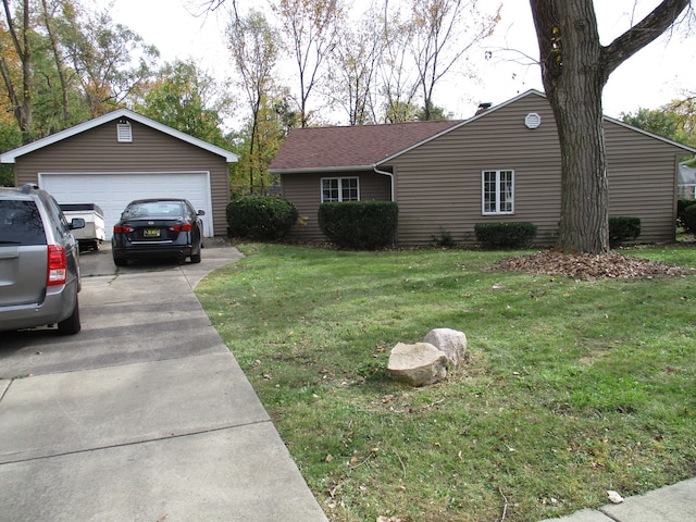 ranch-style house featuring a garage and a front lawn