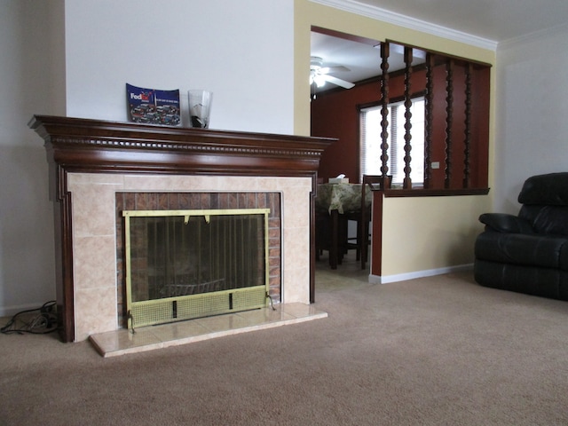 interior details featuring carpet, a tile fireplace, ceiling fan, and crown molding