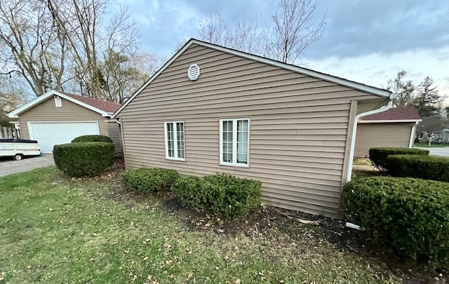 view of side of home featuring a garage