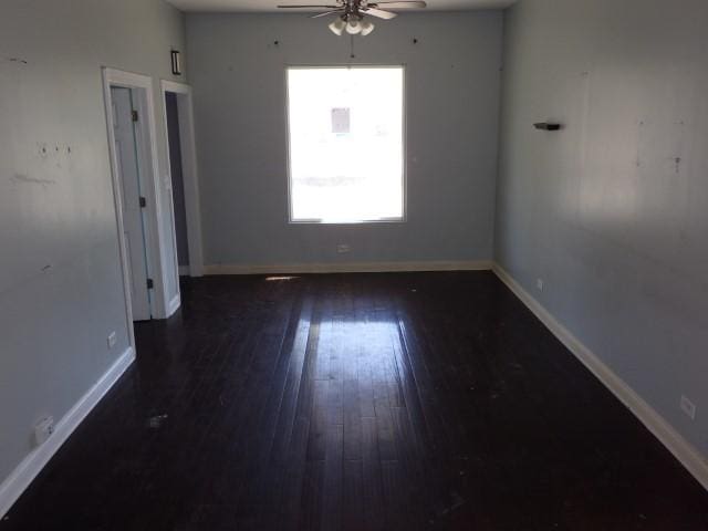 7732 S Muskegon Ave, Chicago, IL 60649 - spare room featuring a ceiling fan, wood-type flooring, and baseboards