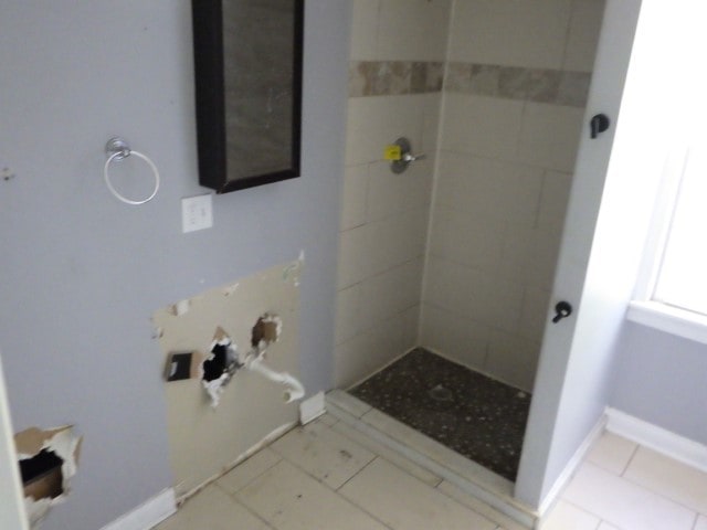 bathroom with tiled shower