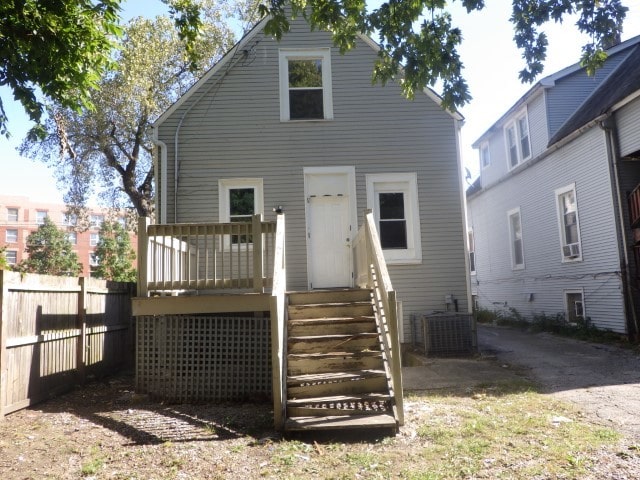 rear view of property with central AC and a deck