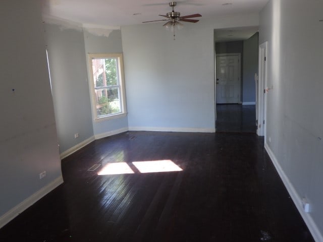 spare room featuring dark hardwood / wood-style floors and ceiling fan