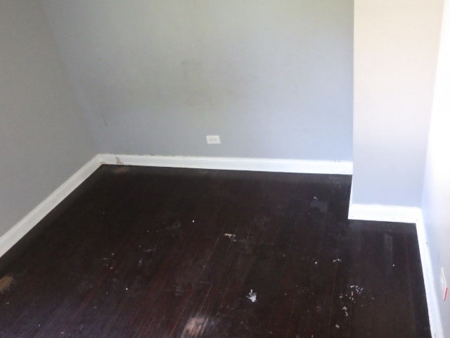 unfurnished room with dark hardwood / wood-style flooring