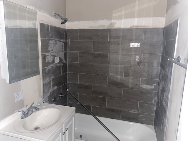 bathroom with vanity and tiled shower / bath combo