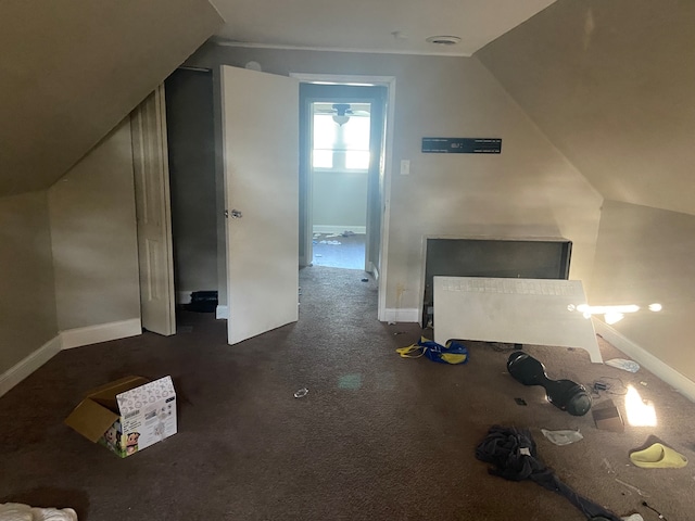 additional living space with lofted ceiling and dark carpet