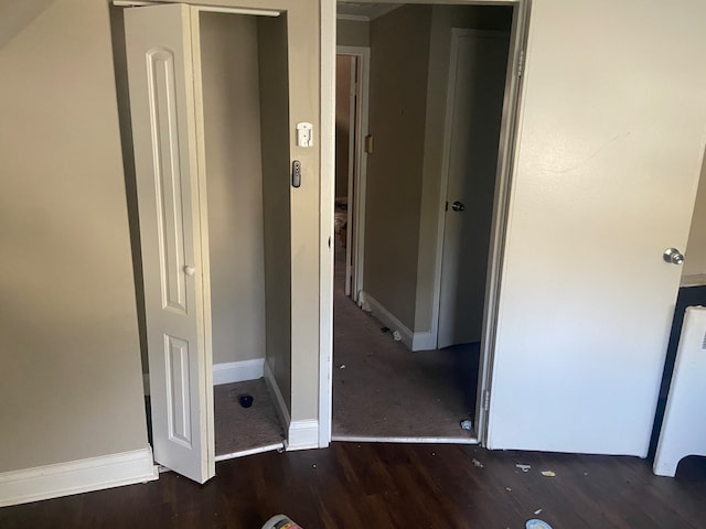 unfurnished bedroom featuring dark hardwood / wood-style flooring and a closet