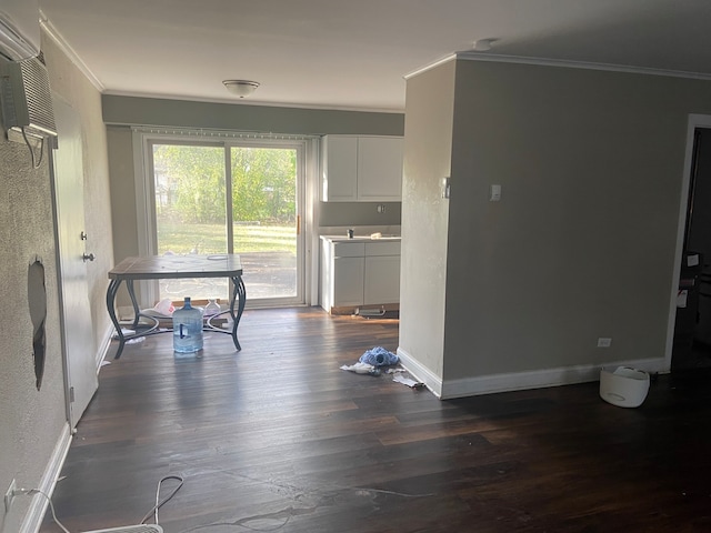 kitchen featuring white cabinets, dark hardwood / wood-style floors, and crown molding