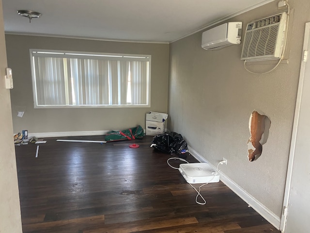 interior space featuring a wall unit AC, dark hardwood / wood-style floors, and crown molding