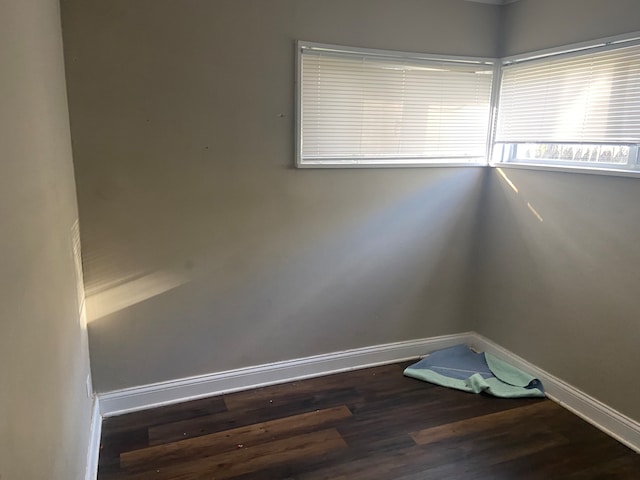 spare room featuring dark hardwood / wood-style flooring