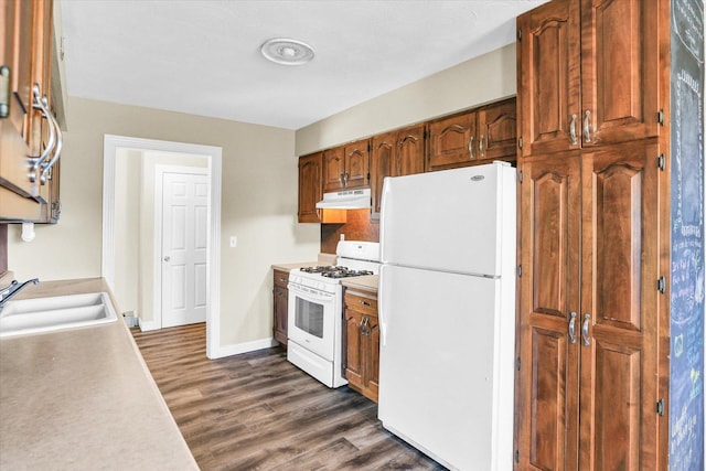 kitchen featuring dark hardwood / wood-style flooring, sink, and white appliances