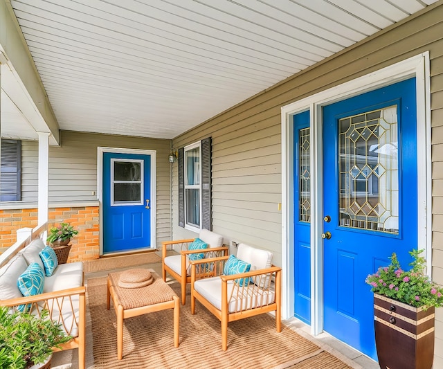 view of exterior entry featuring covered porch