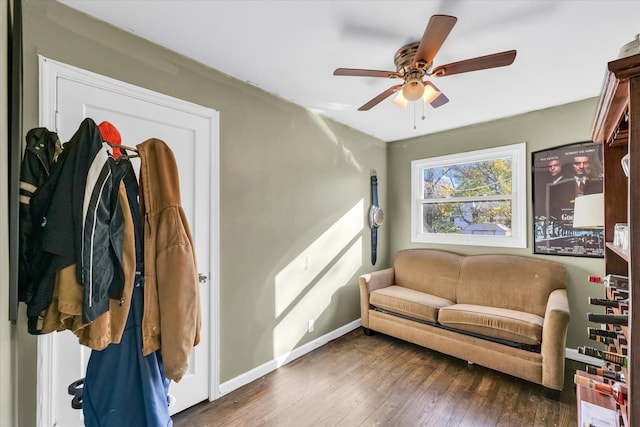 living room with dark hardwood / wood-style floors and ceiling fan