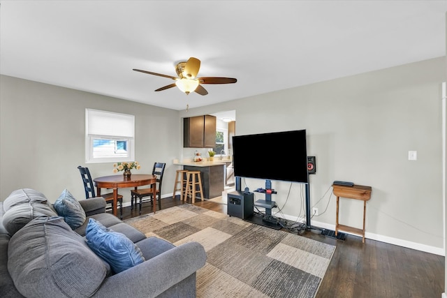 living room featuring dark hardwood / wood-style floors and ceiling fan