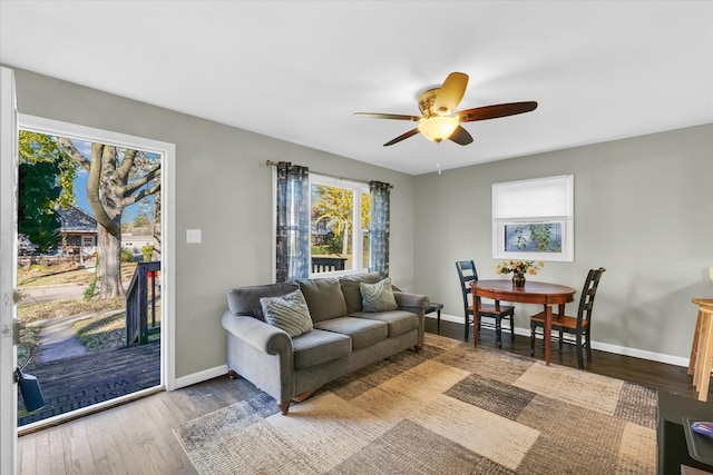 living room with hardwood / wood-style flooring and ceiling fan