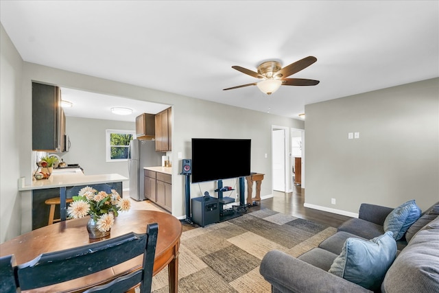 living room featuring ceiling fan and light wood-type flooring