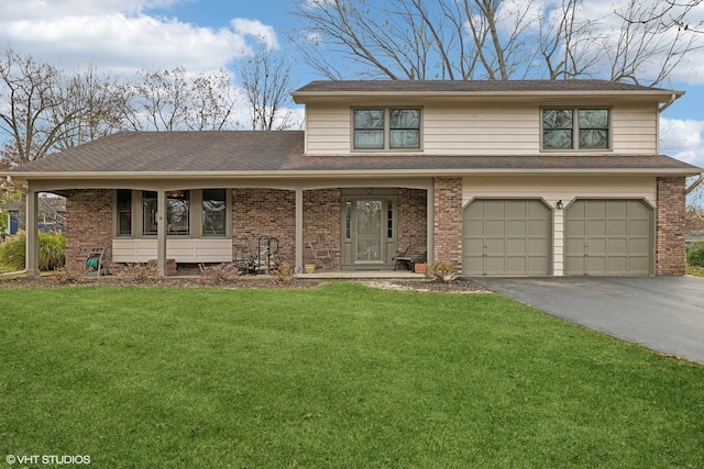 view of front of house with a garage and a front lawn