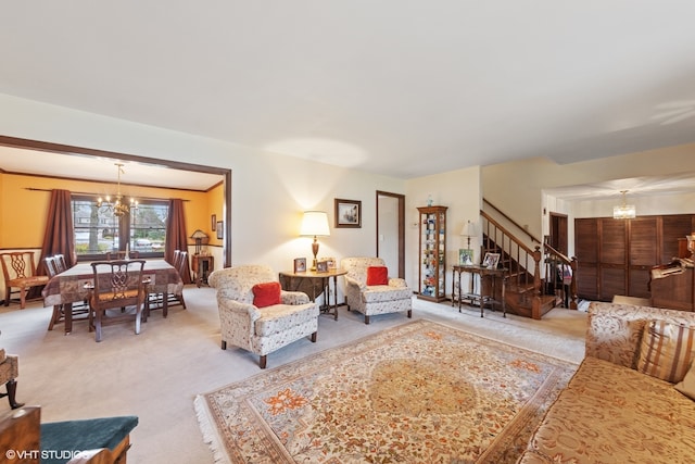 living room featuring light colored carpet and an inviting chandelier