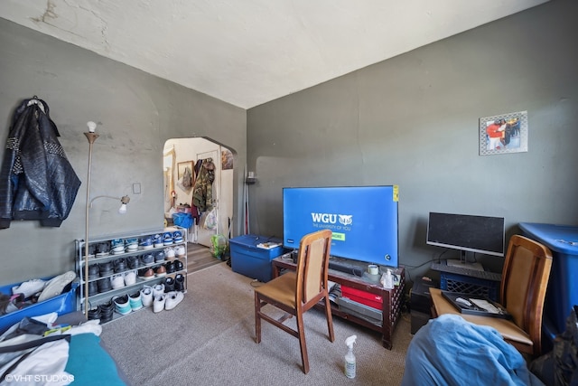 carpeted office space featuring lofted ceiling