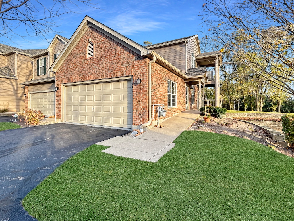 view of side of home with a garage and a lawn