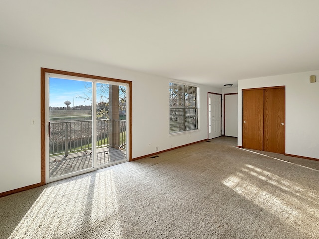 interior space with access to outside, a closet, and carpet flooring